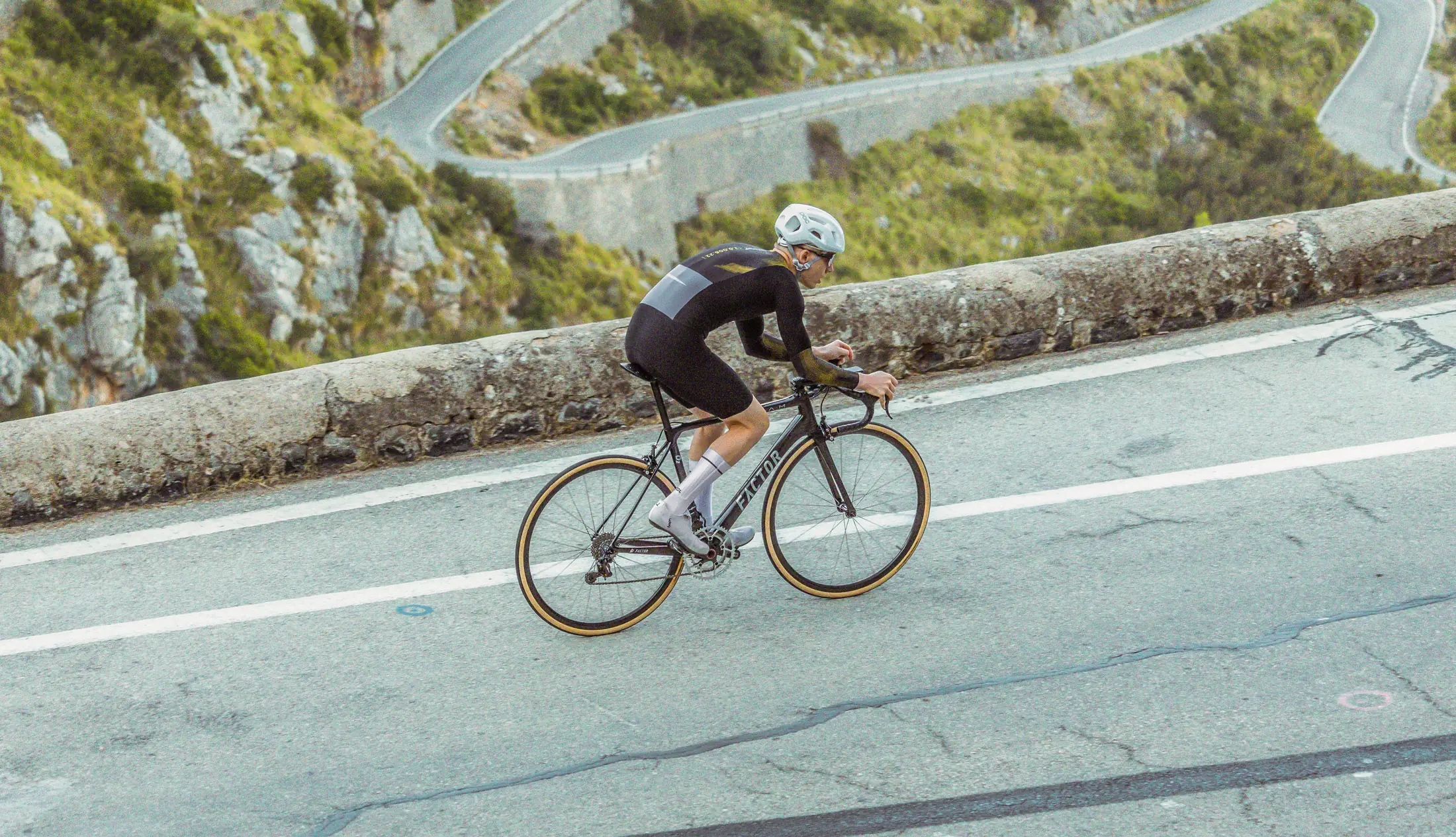 Gareth Winter, Forma's founder, climbing Sa Calobra in Mallorca with the switchbacks below